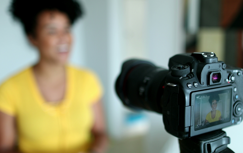 Content creator recording a video with a DSLR camera, showcasing affiliate marketing strategies for passive income.